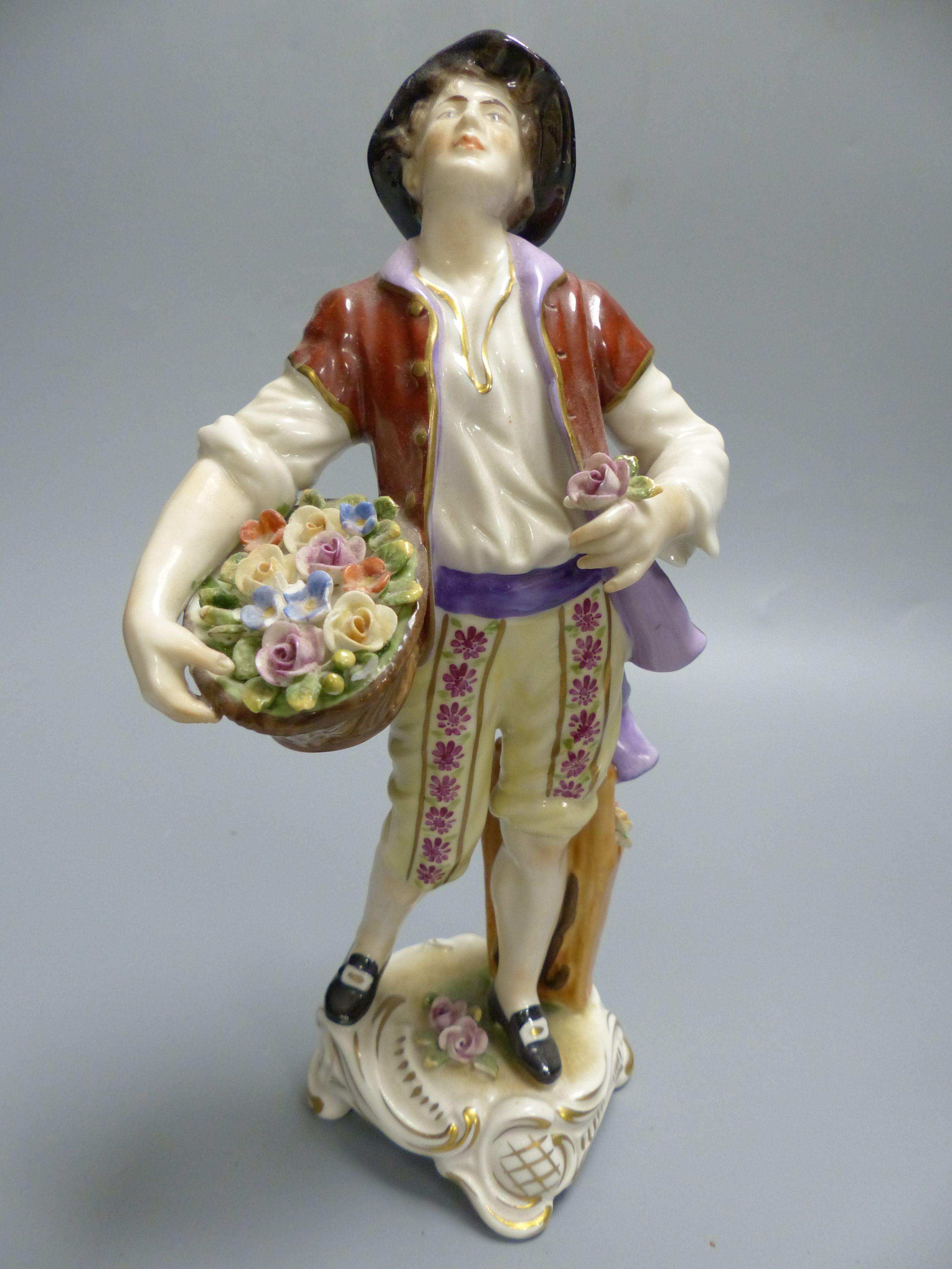 A pair of Rudolf Kammer porcelain figures of flower carriers, height 23cm